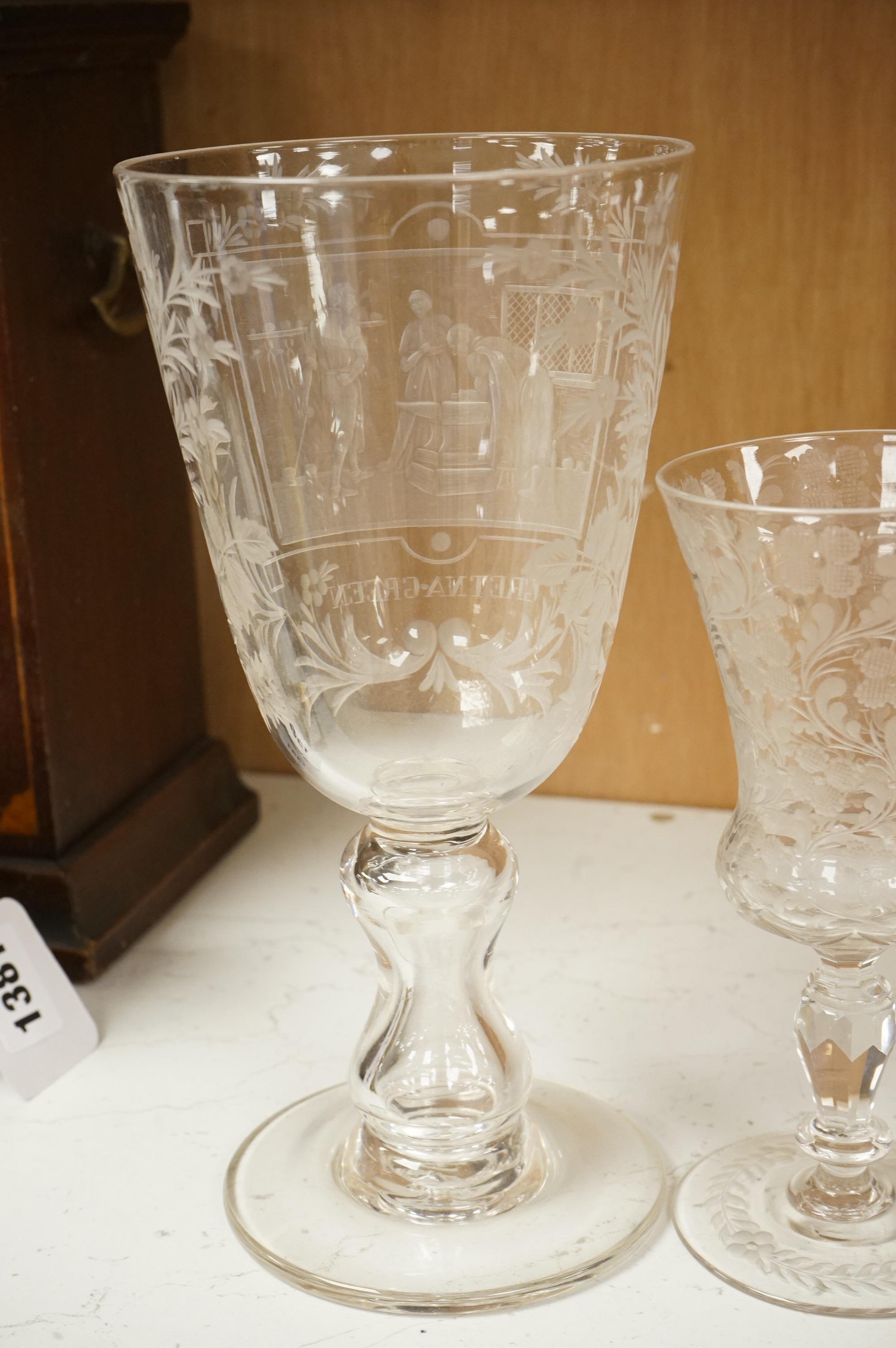 An 18th century sweetmeat glass, a 19th century large wheel engraved ‘Gretna Green’ goblet and a smaller floral engraved glass, tallest 23cm